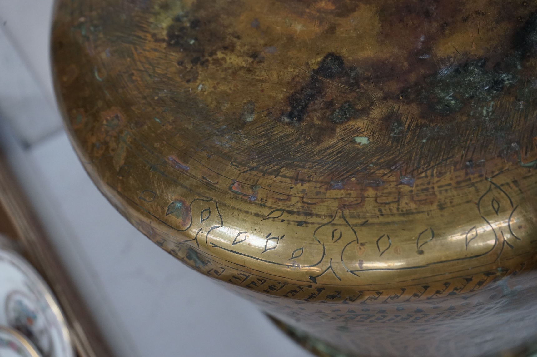A Syrian Islamic copper vessel with detailed surface engraved pattern, 19cm high
